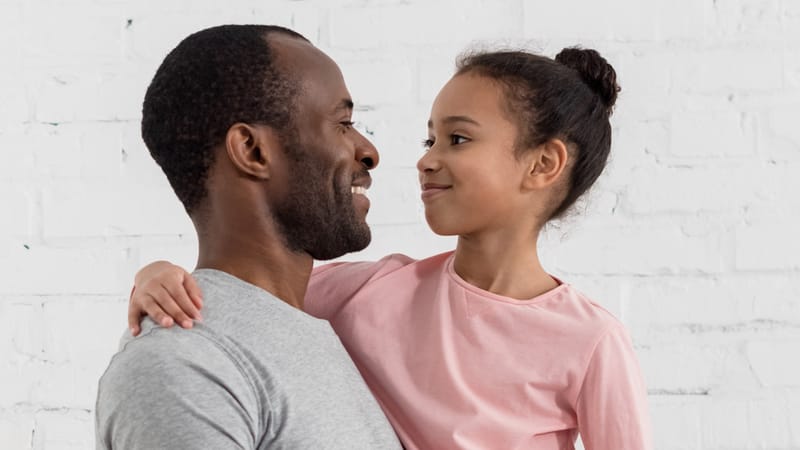Handsome young father holding his daughter at kitchen Handsome young father holding his daughter at kitchen